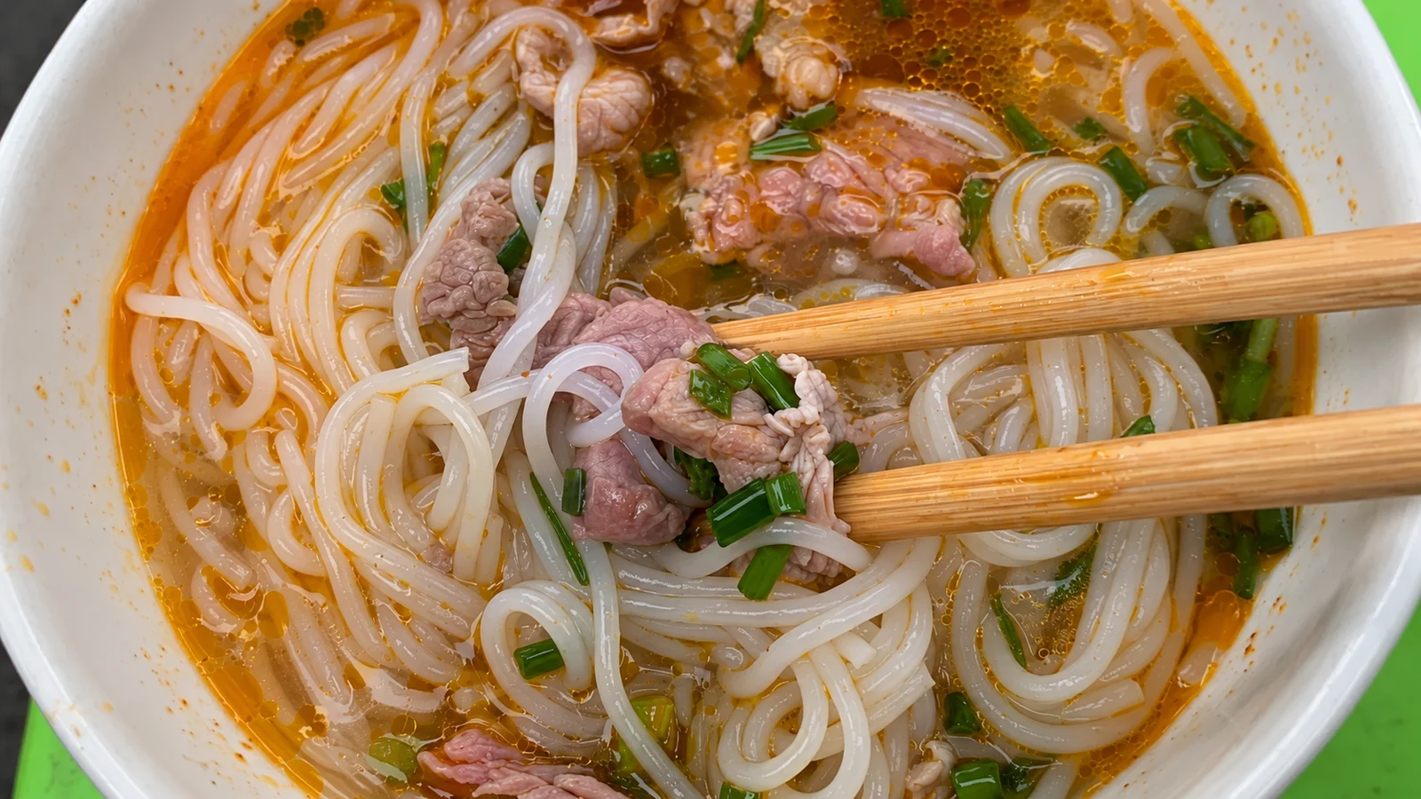 Bún bò Huế with beef, rice noodles and scallions at Đông Ba Market